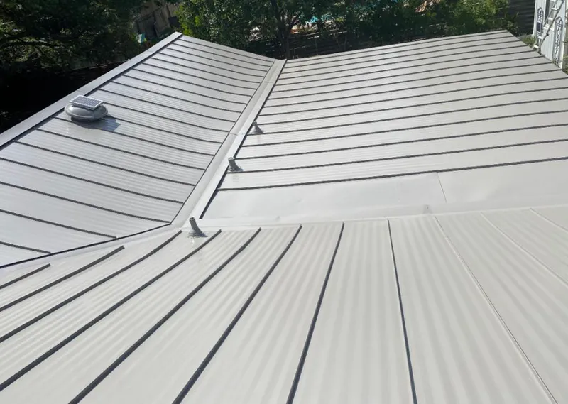 Solar attic fan installed on a metal roof for Roof Ventilation in Opa-locka
